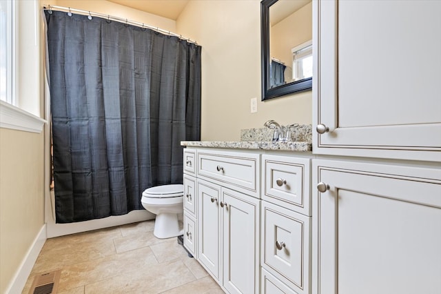 bathroom featuring vanity, toilet, and tile patterned flooring