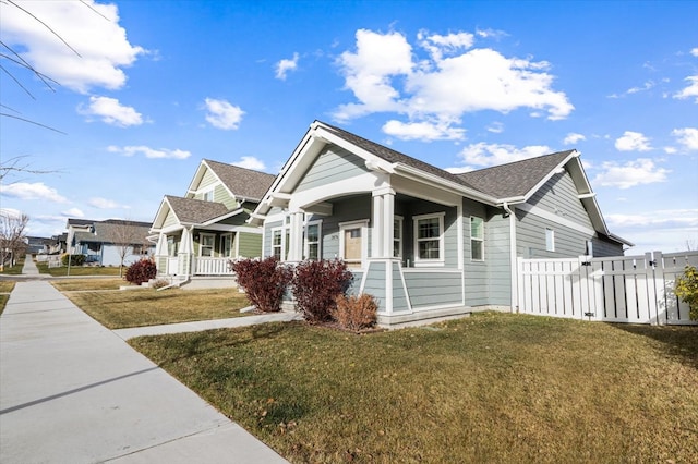 view of home's exterior featuring a porch and a lawn