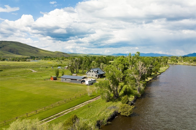 drone / aerial view featuring a water and mountain view and a rural view