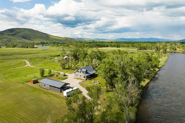 aerial view featuring a water and mountain view and a rural view