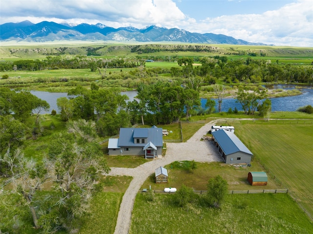 birds eye view of property with a water and mountain view and a rural view