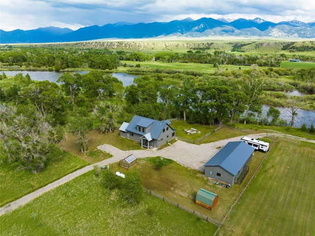 drone / aerial view featuring a rural view and a water and mountain view