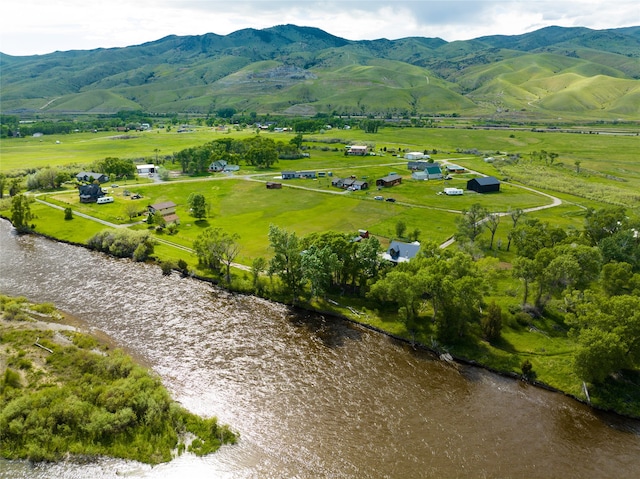 birds eye view of property with a water and mountain view and a rural view