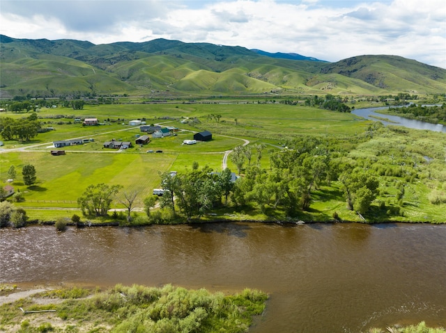 aerial view featuring a water and mountain view and a rural view