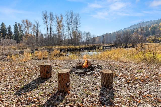 view of yard with a fire pit