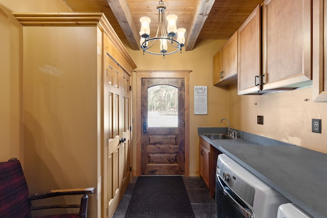 washroom with sink, wooden ceiling, dark tile patterned flooring, cabinets, and an inviting chandelier