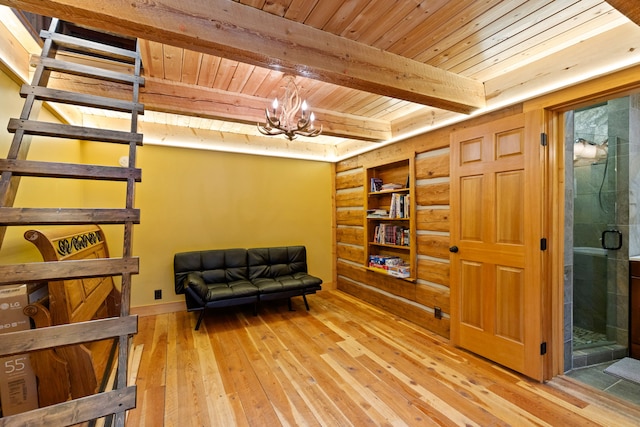 sitting room featuring beamed ceiling, light hardwood / wood-style flooring, an inviting chandelier, and wood ceiling