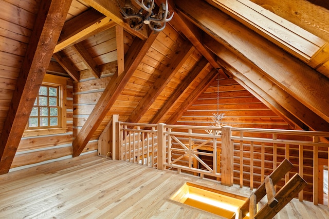 additional living space with wood-type flooring, vaulted ceiling with beams, and wooden ceiling