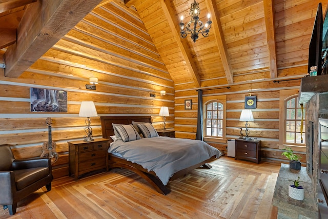 bedroom featuring beam ceiling, multiple windows, light hardwood / wood-style flooring, and wood ceiling