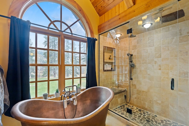 bathroom with lofted ceiling, a wealth of natural light, and independent shower and bath