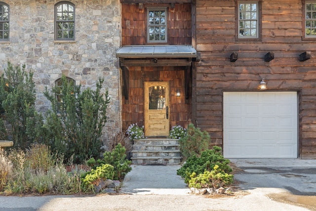 view of exterior entry with a garage