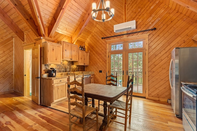 dining room with french doors, high vaulted ceiling, an AC wall unit, light hardwood / wood-style floors, and wood walls