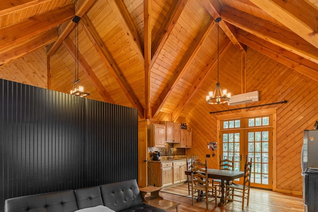 interior space with beamed ceiling, light hardwood / wood-style flooring, an AC wall unit, and sink