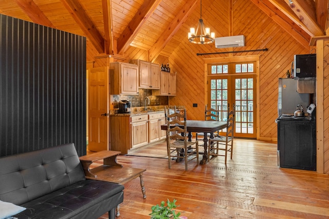 dining space featuring a wall mounted AC, wood walls, beamed ceiling, and light wood-type flooring