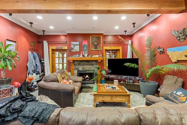 living room featuring ornamental molding, a stone fireplace, and beamed ceiling