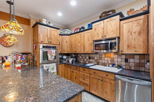 kitchen featuring ornamental molding, appliances with stainless steel finishes, dark stone counters, and pendant lighting