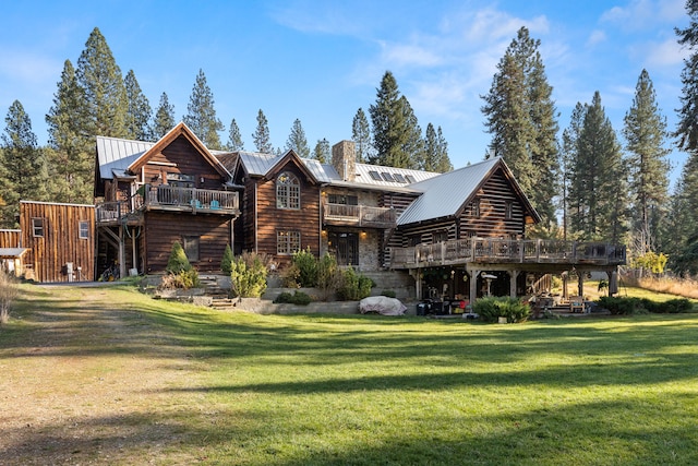 back of property featuring a lawn and a deck