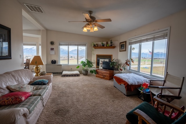 carpeted living room with vaulted ceiling and ceiling fan