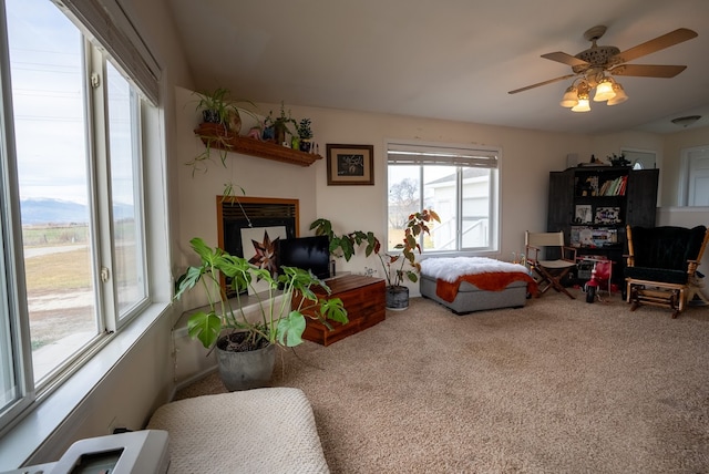 bedroom with a fireplace, carpet floors, and ceiling fan