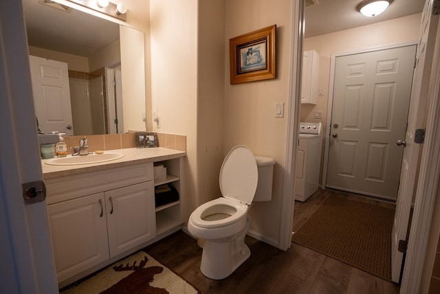 bathroom with washer / clothes dryer, vanity, wood-type flooring, and toilet