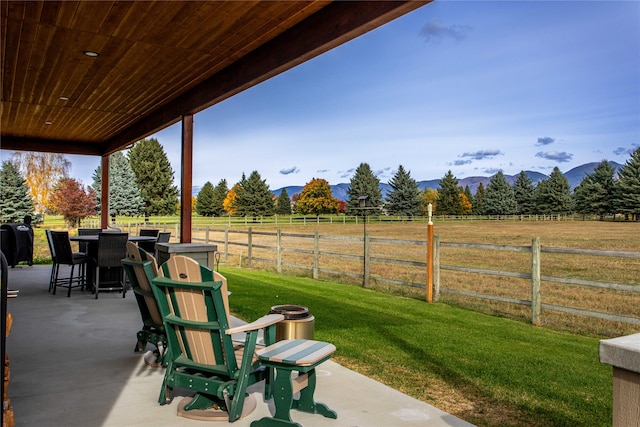 view of patio / terrace with a mountain view and a rural view