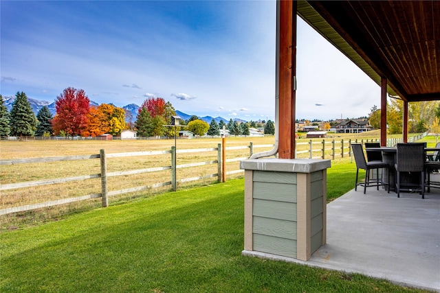 view of yard with a mountain view and a patio