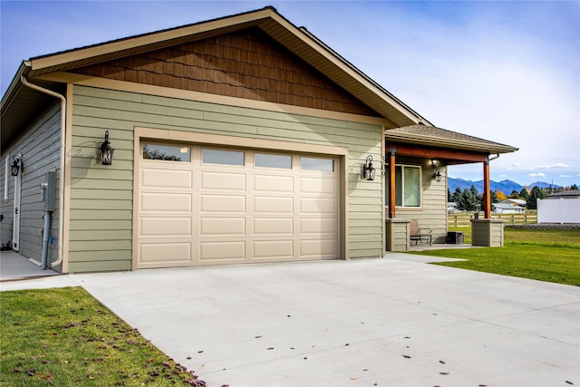 309 Kari Ln, Polson, MT 59860 - view of front of house featuring driveway, a mountain view, and a front lawn