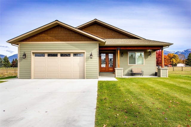 view of front of property with a mountain view, a garage, and a front yard