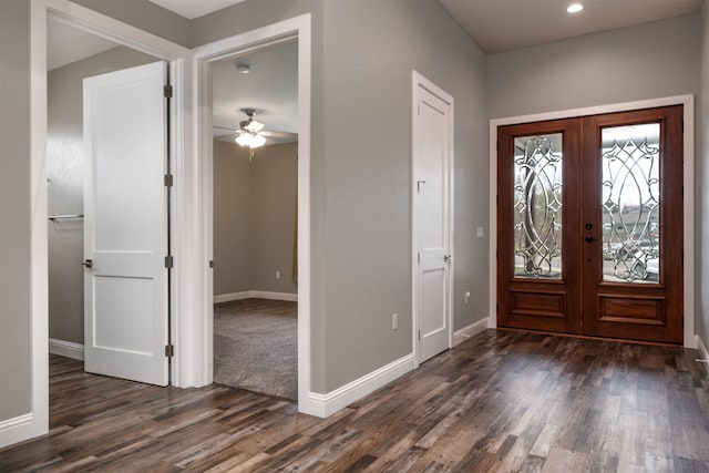 foyer featuring french doors, ceiling fan, and dark wood-type flooring