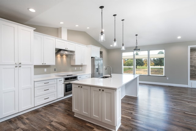 kitchen with lofted ceiling, a center island with sink, white cabinets, hanging light fixtures, and appliances with stainless steel finishes