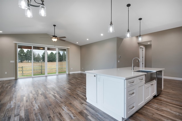 kitchen featuring white cabinetry, dark wood-type flooring, an island with sink, lofted ceiling, and decorative light fixtures