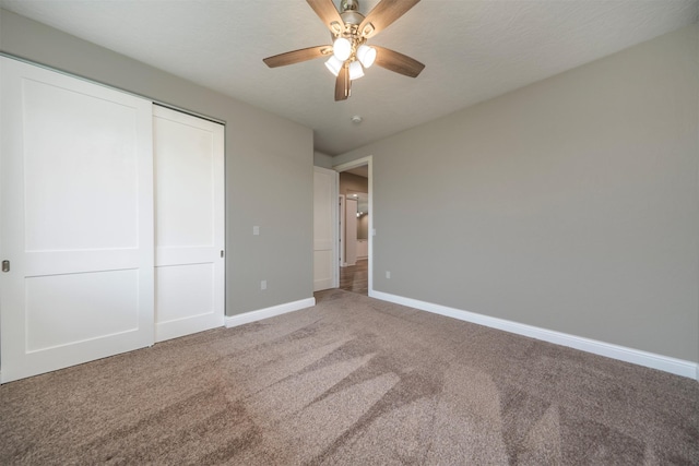 309 Kari Ln, Polson, MT 59860 - unfurnished bedroom featuring light colored carpet, baseboards, a closet, and ceiling fan
