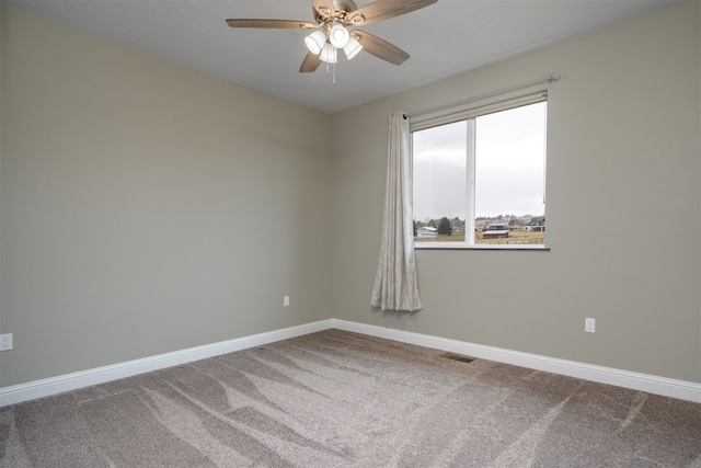 empty room featuring ceiling fan and carpet floors