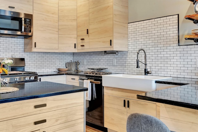 kitchen featuring tasteful backsplash, light brown cabinetry, and black appliances