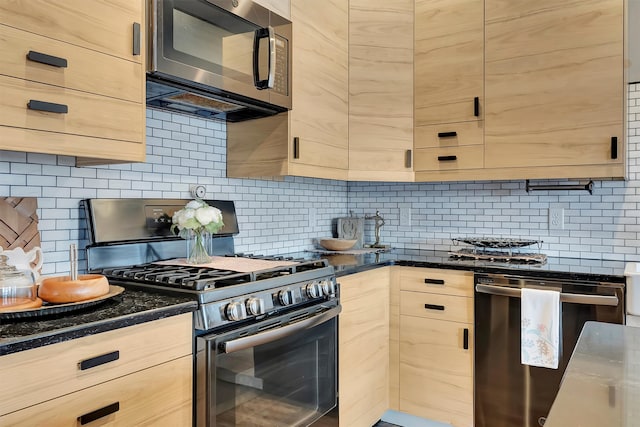 kitchen featuring appliances with stainless steel finishes, backsplash, dark stone counters, and light brown cabinetry