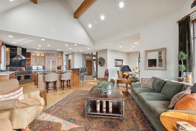 living room featuring beam ceiling, high vaulted ceiling, and light hardwood / wood-style floors