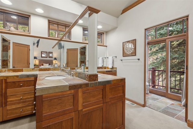 bathroom featuring a towering ceiling and vanity