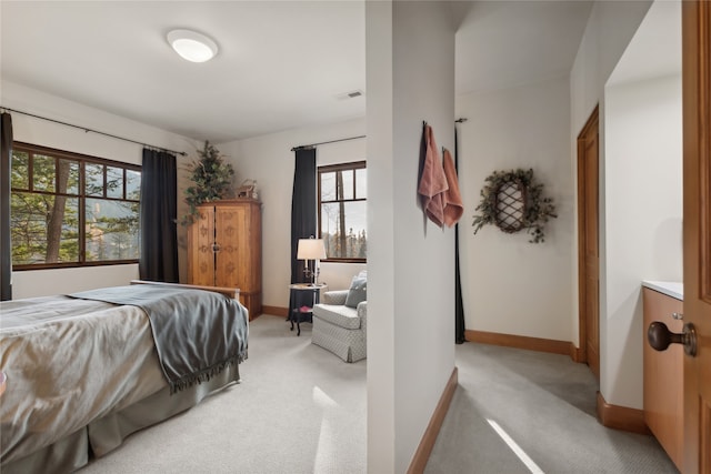 carpeted bedroom featuring multiple windows