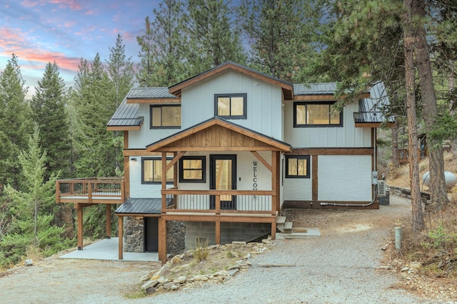 469 Owings Creek Loop, Hamilton, MT 59840 - view of front facade featuring a standing seam roof, a metal roof, gravel driveway, and a wooden deck