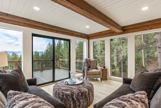 sunroom / solarium featuring beamed ceiling and wooden ceiling