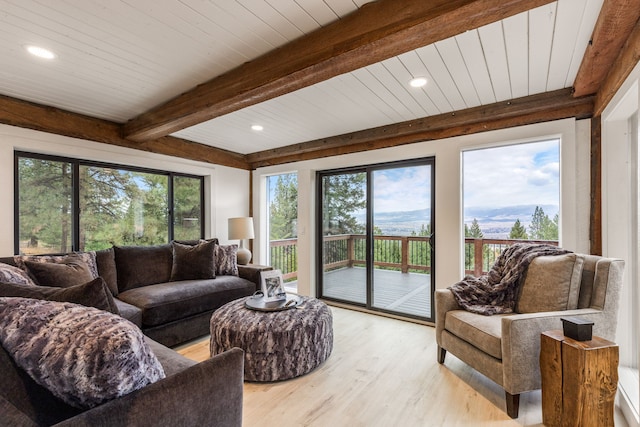 living room featuring beam ceiling, wooden ceiling, and light wood-type flooring