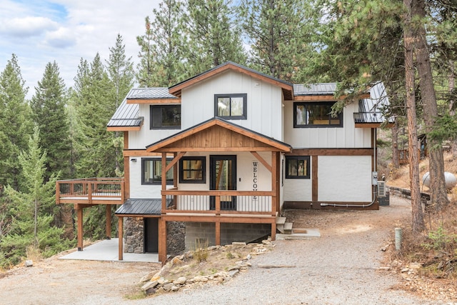 469 Owings Creek Loop, Hamilton, MT 59840 - view of front of home with a standing seam roof, a metal roof, driveway, a deck, and a porch
