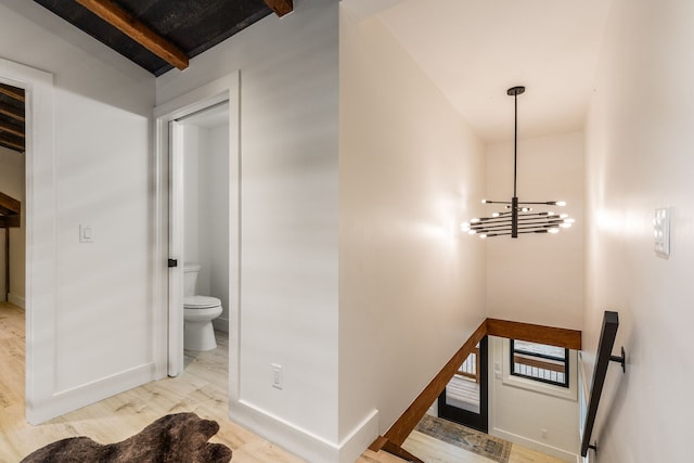 469 Owings Creek Loop, Hamilton, MT 59840 - stairs featuring wood finished floors, a chandelier, and beam ceiling