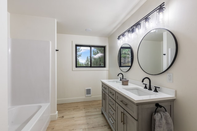 bathroom with vanity and hardwood / wood-style flooring