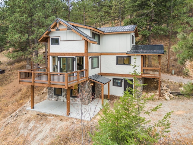 469 Owings Creek Loop, Hamilton, MT 59840 - rear view of property with a metal roof, a patio area, a deck, and stone siding
