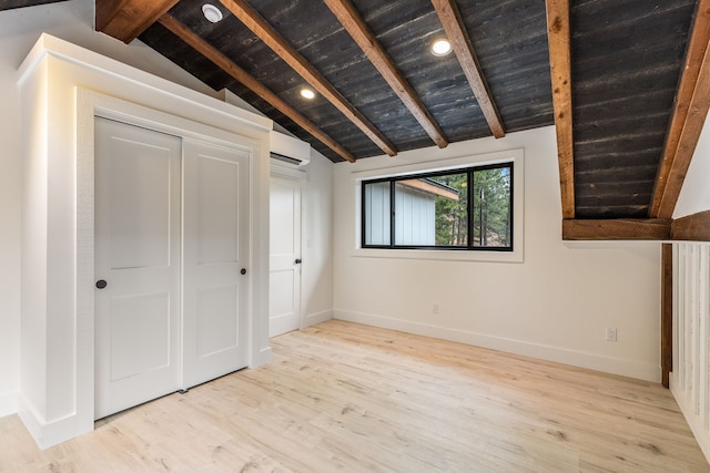 unfurnished bedroom featuring wooden ceiling, lofted ceiling with beams, an AC wall unit, light hardwood / wood-style floors, and a closet