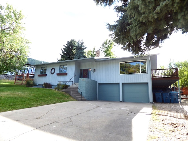 view of front of house featuring a garage, a front lawn, and a deck