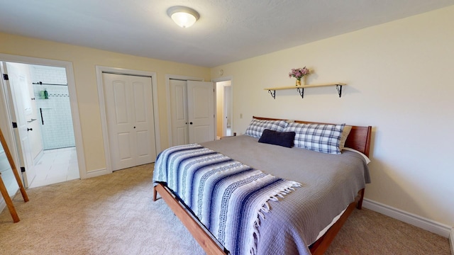 carpeted bedroom featuring two closets