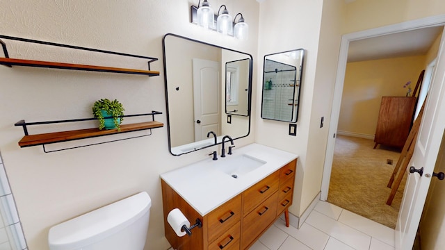 bathroom featuring tile patterned floors, vanity, and toilet