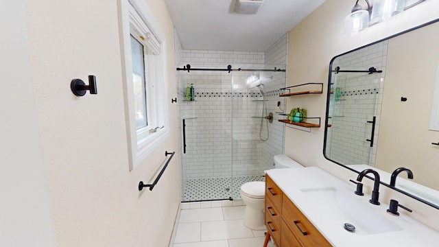 bathroom featuring tile patterned floors, vanity, toilet, and walk in shower